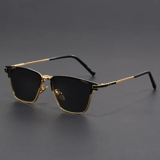 Sunglasses with gold frames and black lenses on a gray background